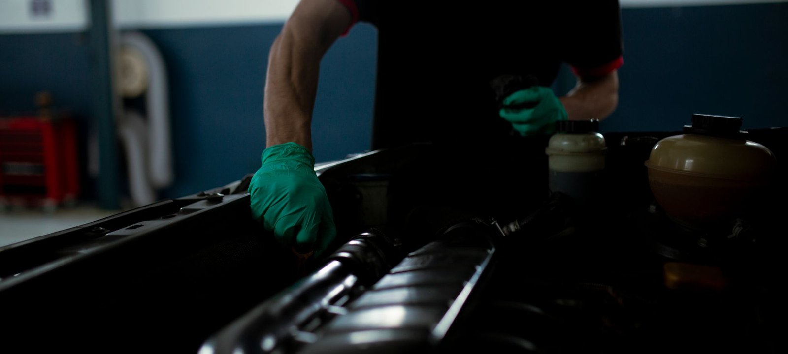 Demo image: mechanic inspecting a vehicle engine bay